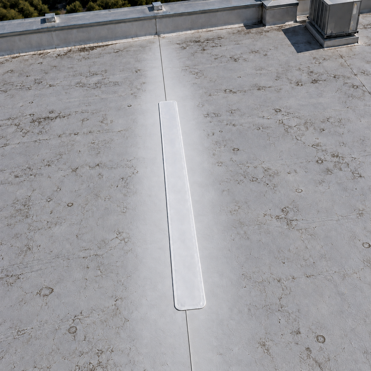 Illustrative aerial view of a white TPO seam repair strip on a lightly weathered commercial roof, with clean membrane beside the patch and a single seam continuing past both ends.