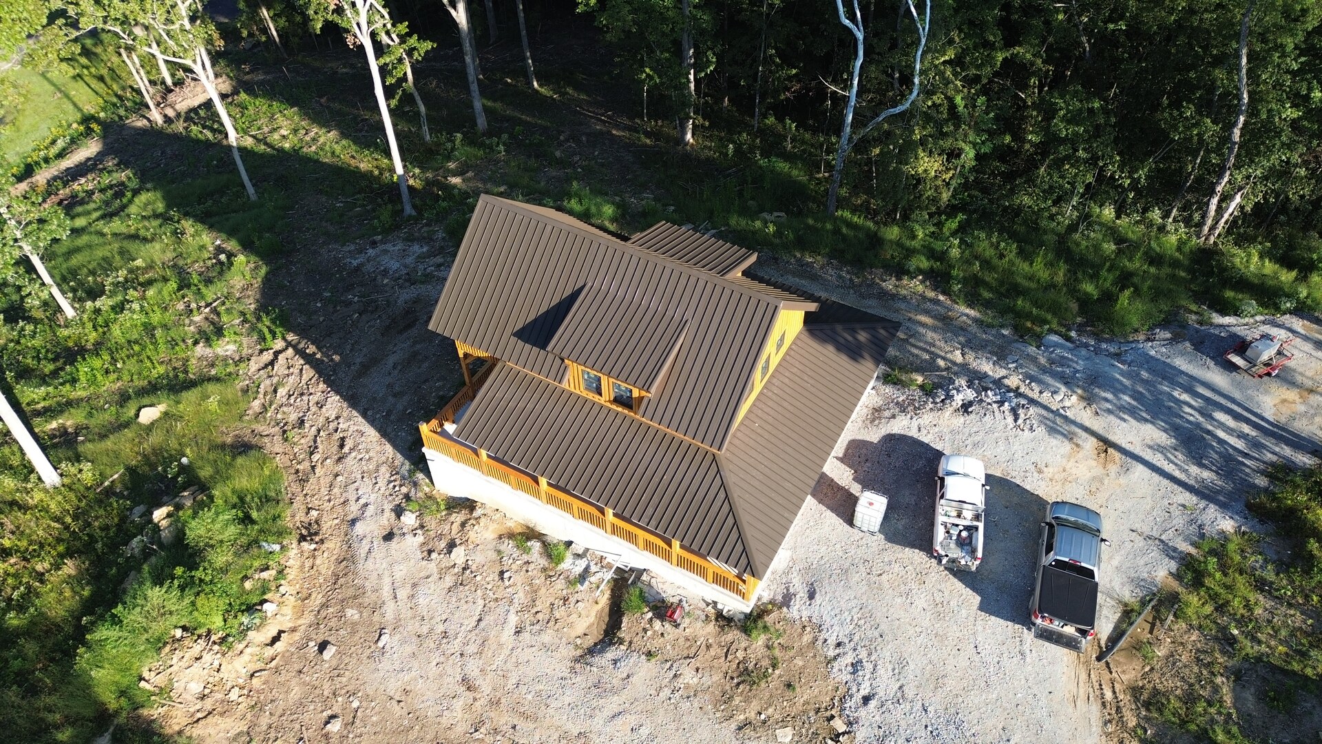 Aerial side view of cabin one with its brown metal roof in Pleasureville, Kentucky.