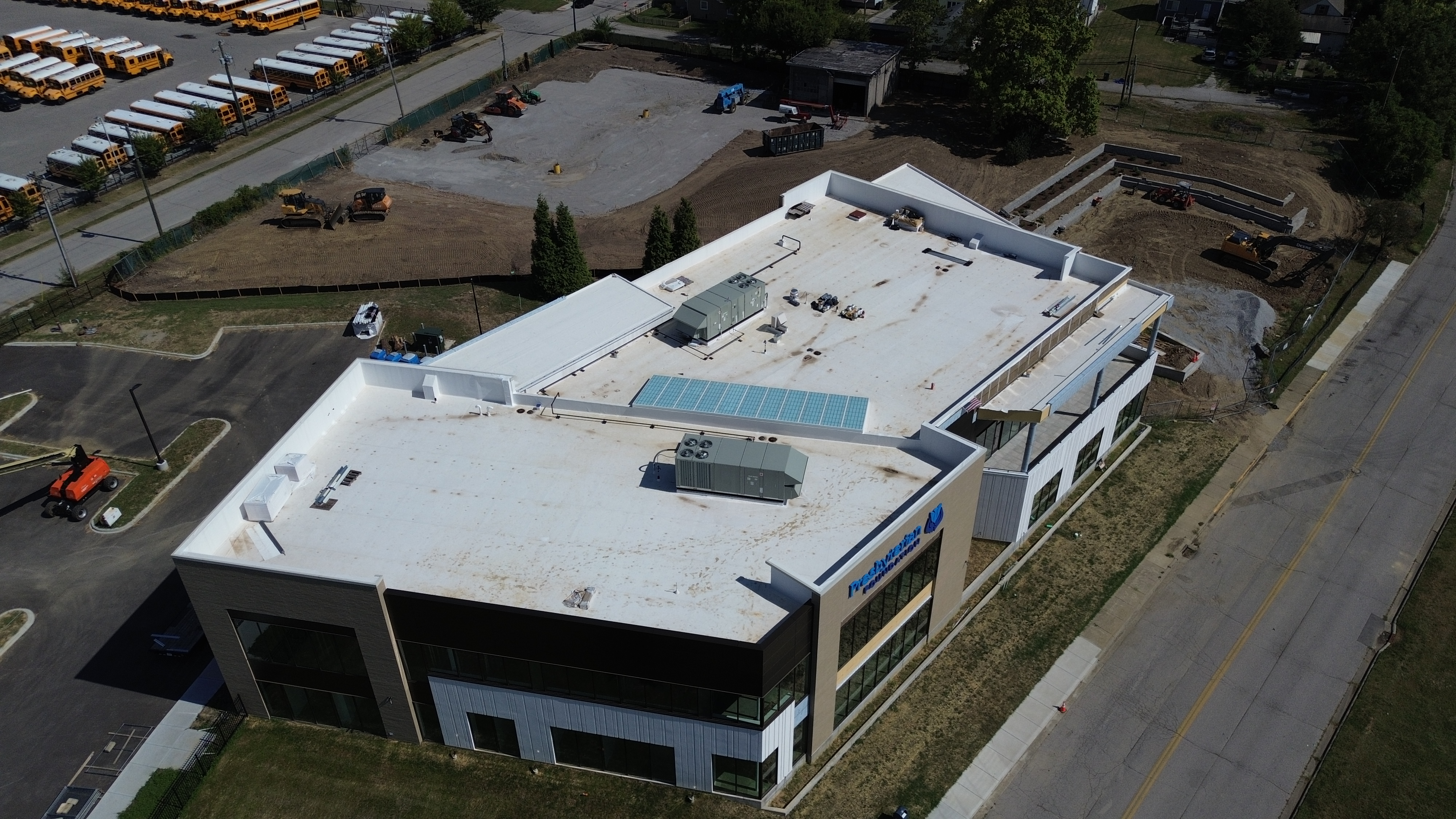 Aerial view of the completed 9,500 sq ft mechanically attached TPO low-slope roof with 7-foot parapet walls on the Charity Foundation Building in Clarksville, Indiana.