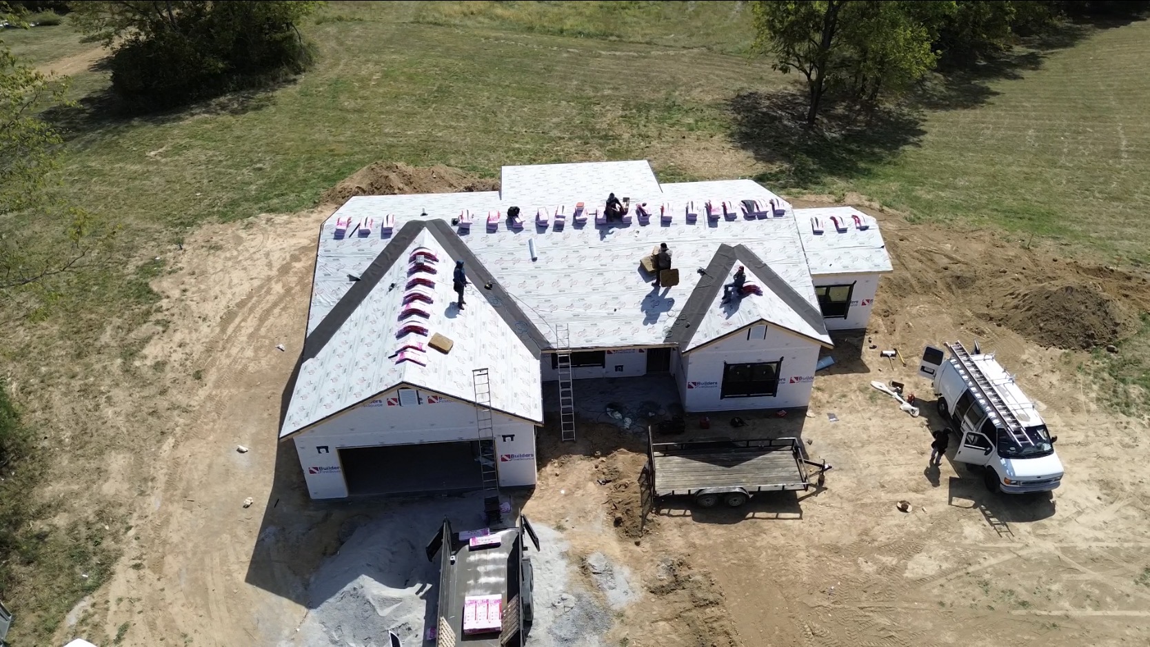 Aerial view of a residential roof installation in progress.
